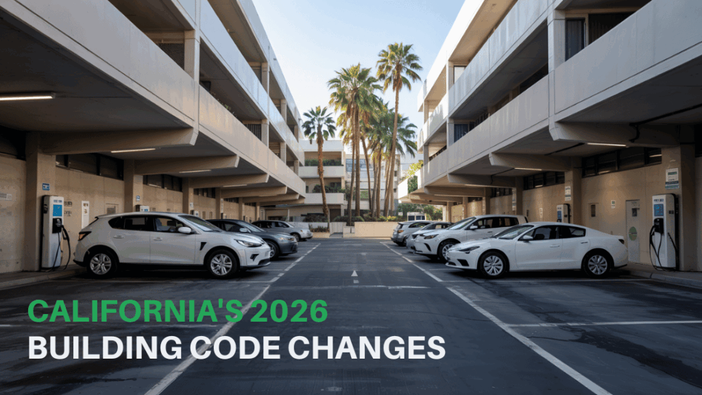 EV-ready parking garage at a modern California apartment complex, with white electric vehicles charging at designated stations under multi-story buildings, illustrating new 2026 California building code requirements for electric vehicle infrastructure.