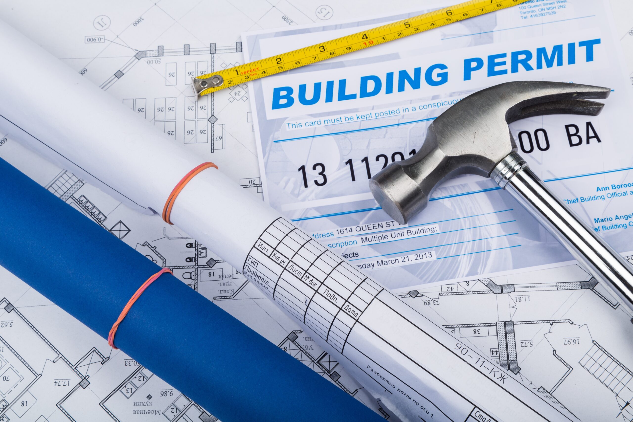 building permit concept with papers and hammer